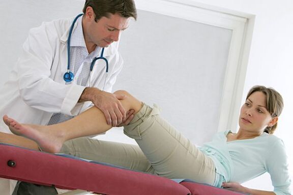Doctor checking leg after varicose vein surgery